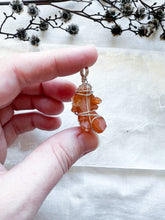 Load image into Gallery viewer, Silver wrapped Tangerine Quartz pendant
